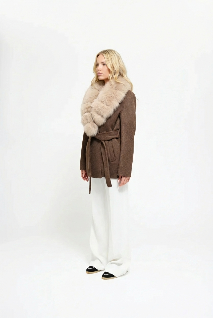 Woman wearing a brown coat with a fur collar on a white background