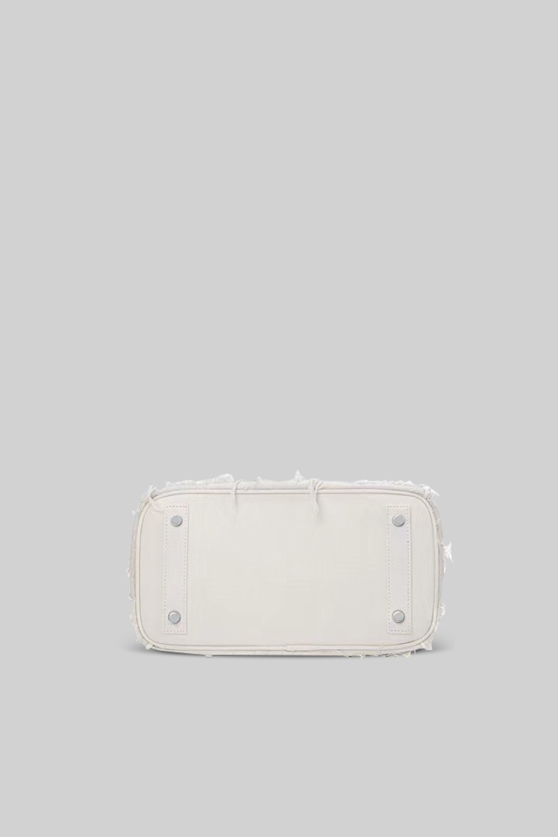 White rectangular pouch with decorative elements on a light gray background