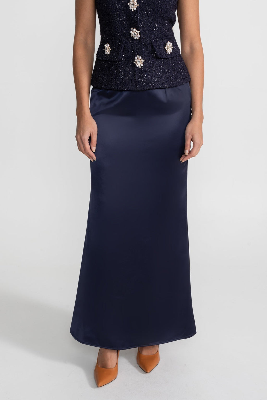 Navy blue dress with floral embellishments on a white background
