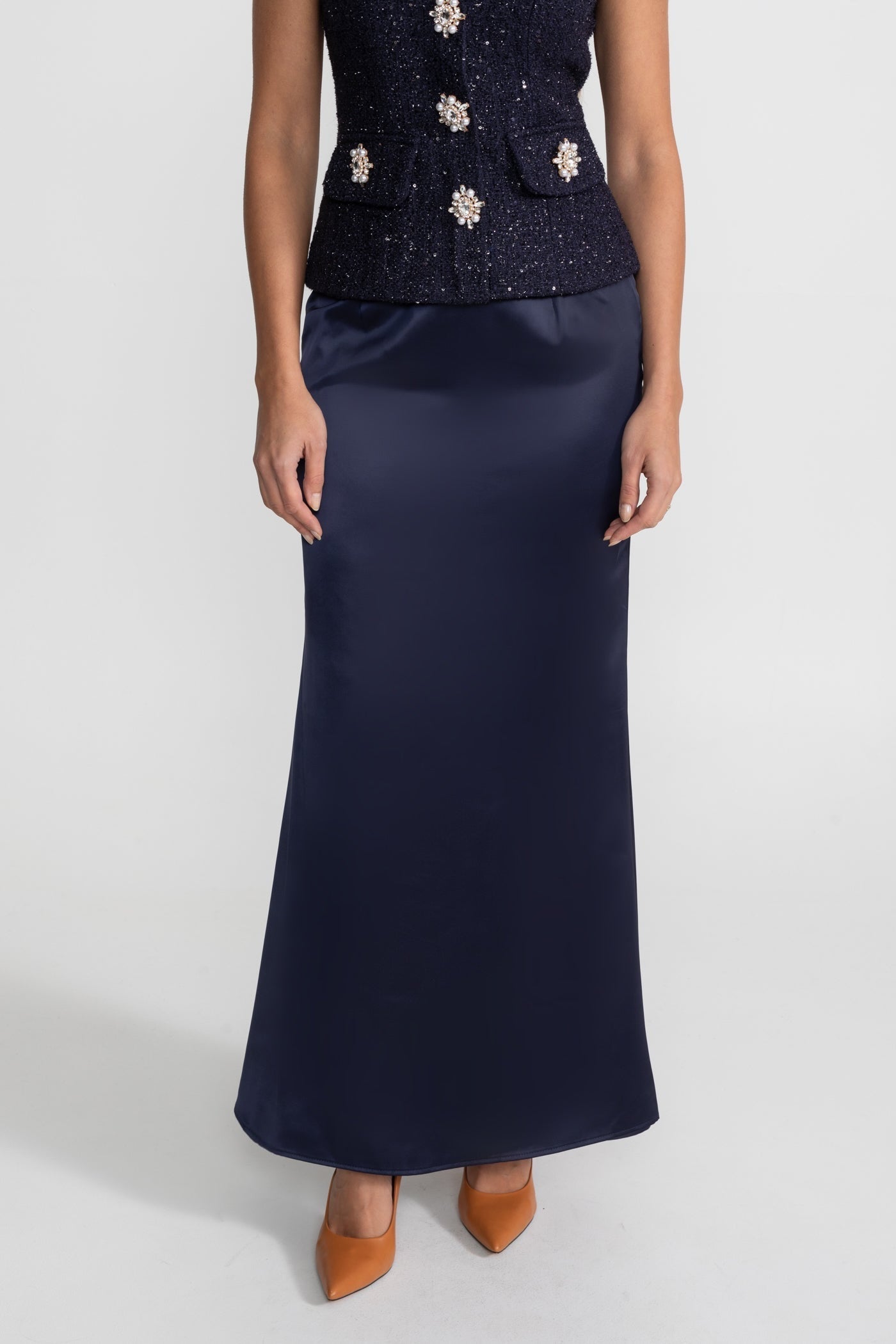 Navy blue dress with floral embellishments on a white background