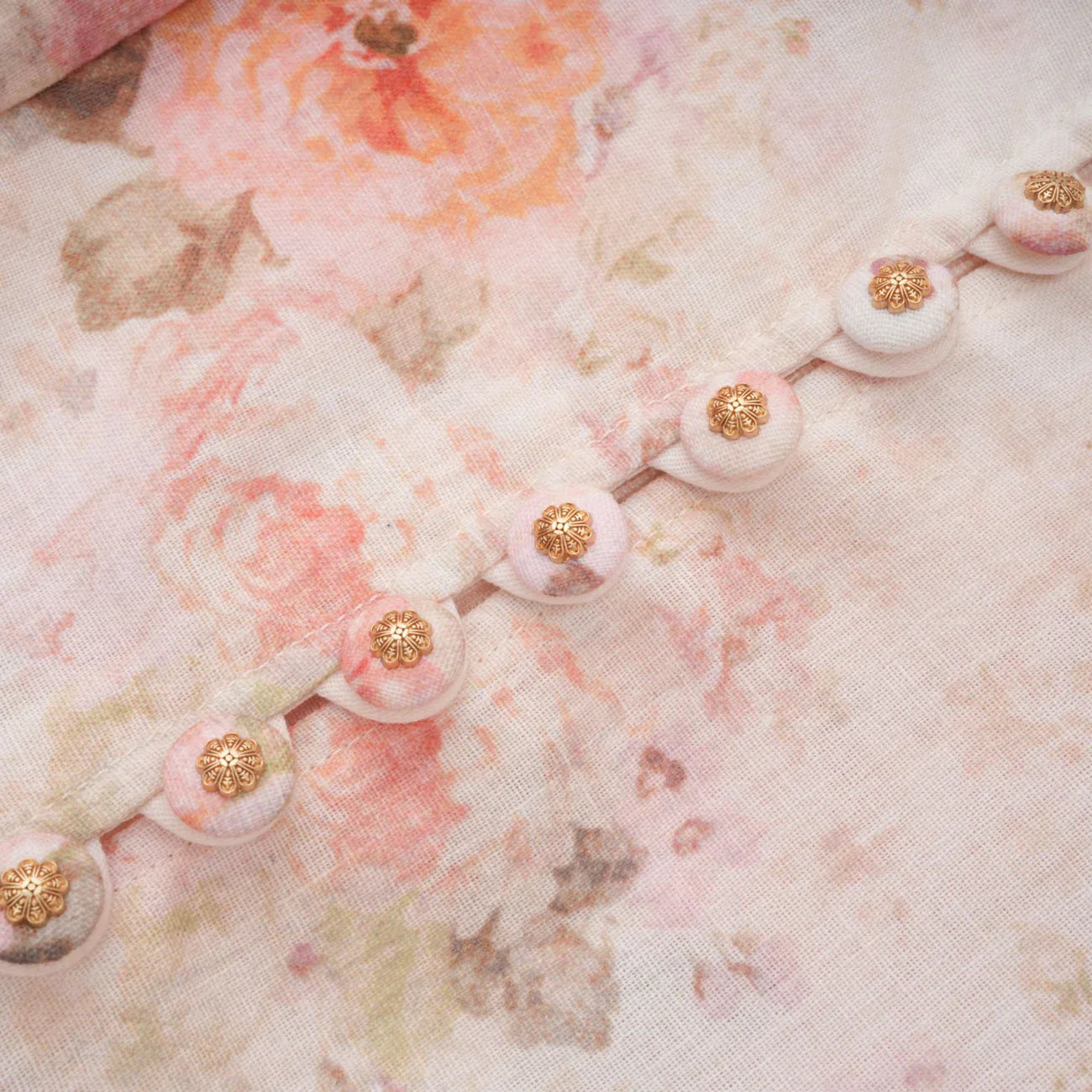 Close-up of floral fabric with pink and gold accents