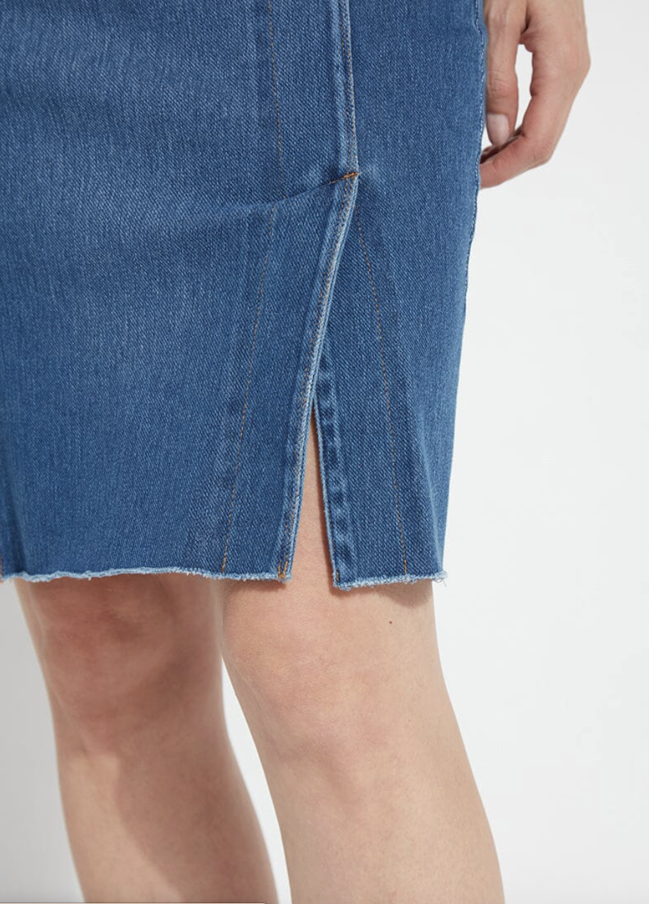 Close-up of a blue denim skirt with a white background