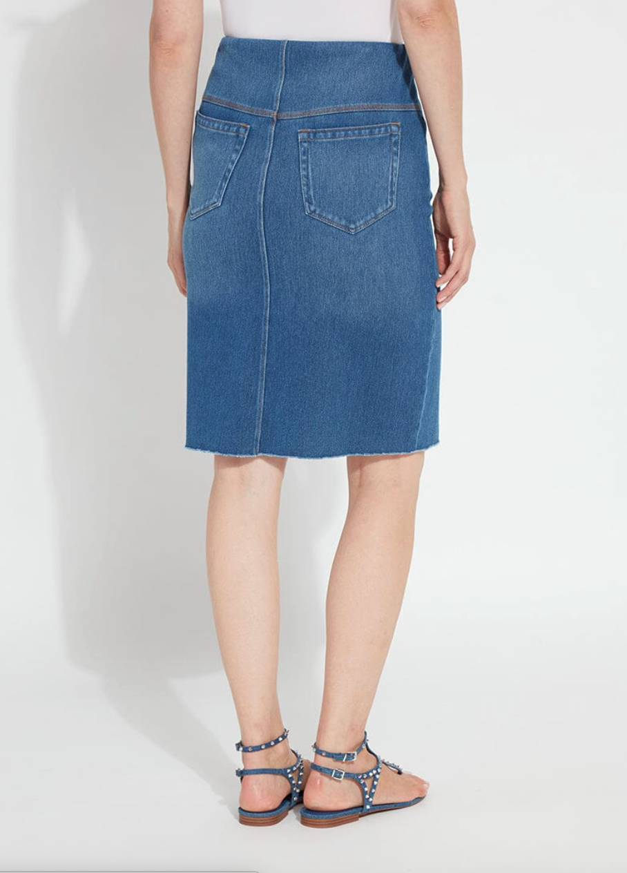 Person wearing a blue denim skirt on a white background