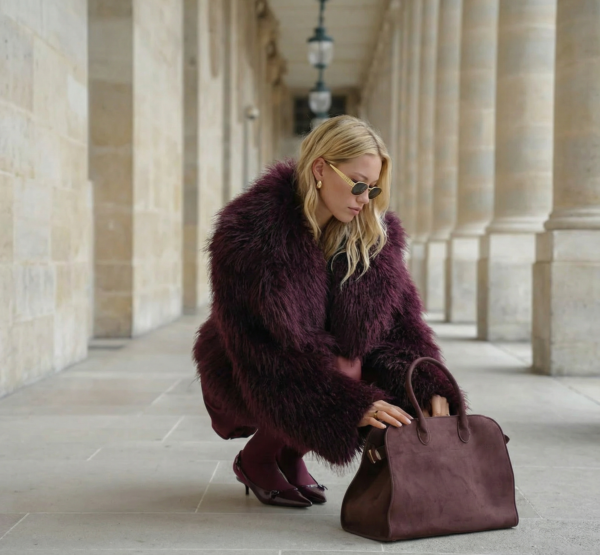 Woman in a fur coat with a matching handbag in an architectural setting