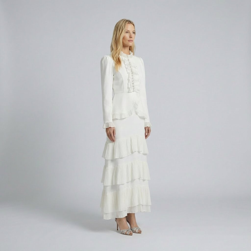 Woman wearing a white dress with ruffled layers on a plain background