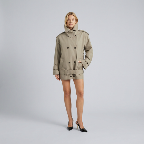 Woman wearing a beige trench coat on a gray background