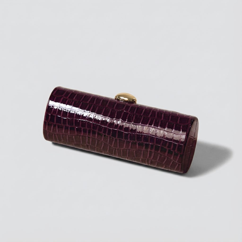 Purple crocodile-patterned clutch bag on a light gray background