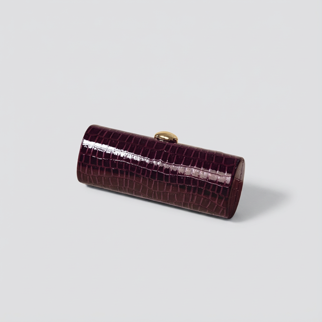 Brown crocodile-patterned clutch bag on a light gray background
