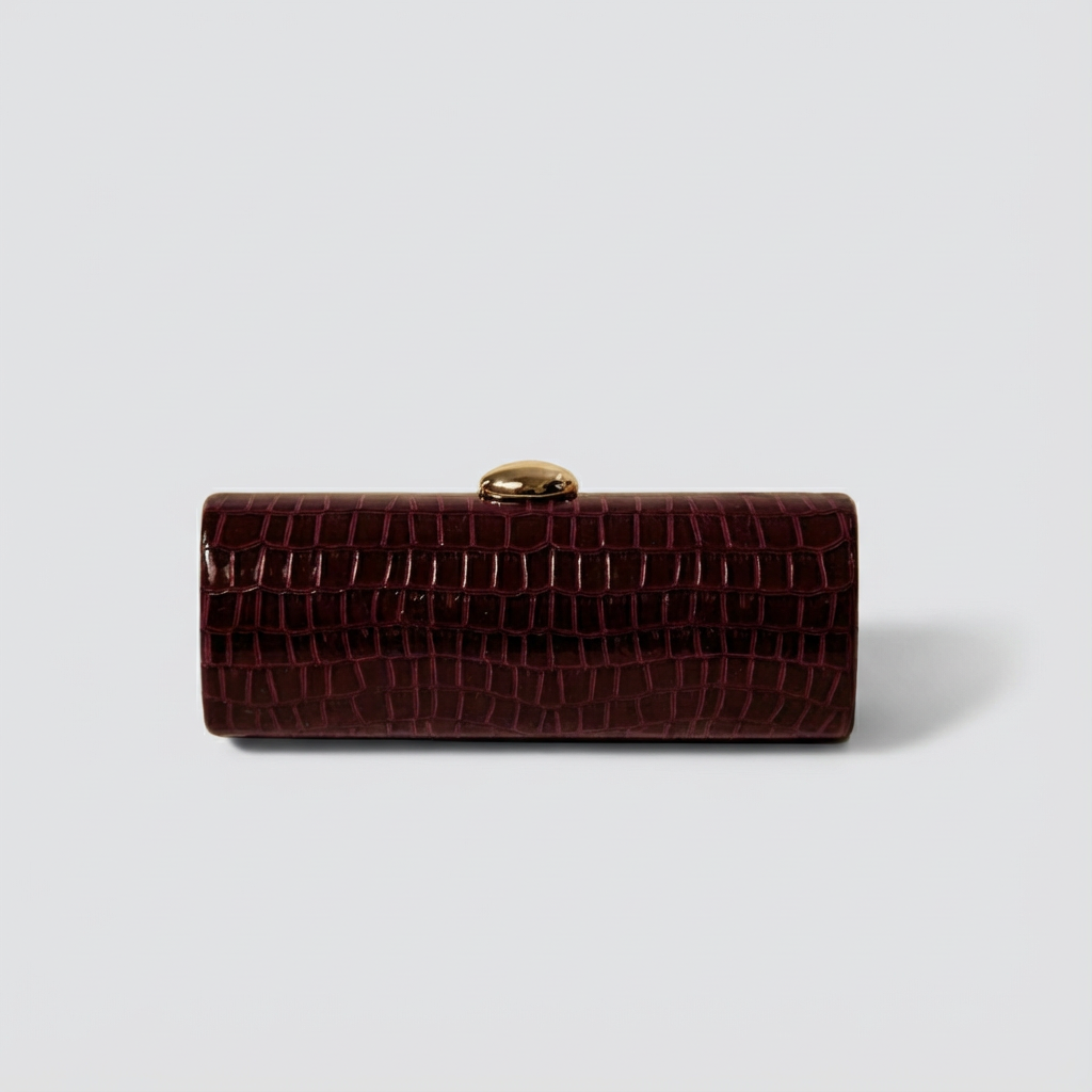 Brown crocodile-patterned clutch bag on a light gray background