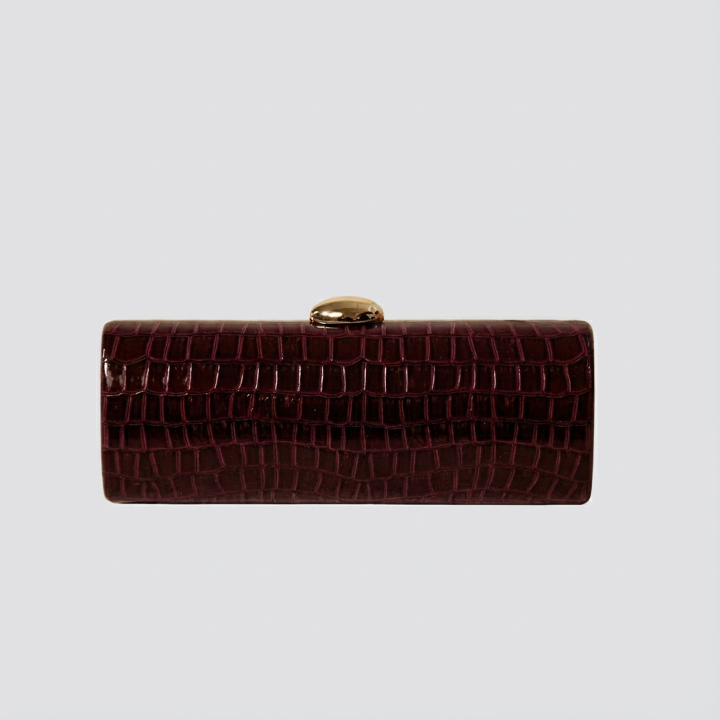 Brown crocodile-patterned clutch bag on a light gray background
