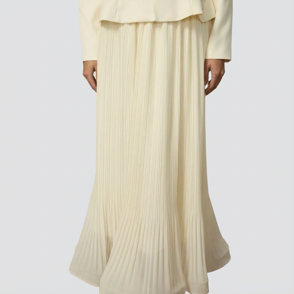 Beige pleated skirt worn by a person on a white background
