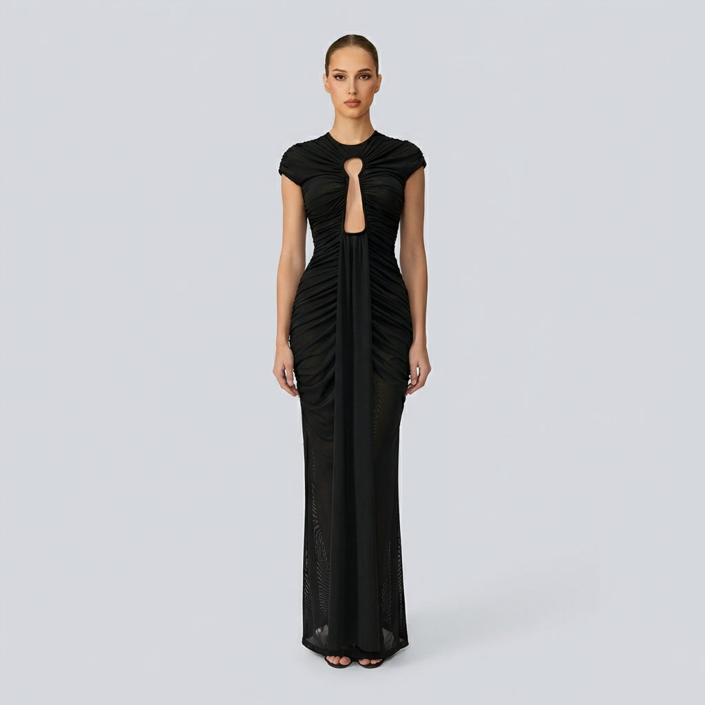Black evening gown with a cutout design on a gray background