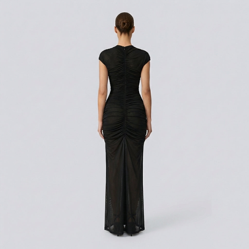 Black evening gown on a model against a light gray background
